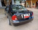 Ford Laser Ghia 1.8 MT 2004 - Bán xe Ford Laser Ghia 1.8 MT sản xuất năm 2004, màu đen, 200 triệu