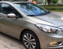 Kia K3 1.6 AT  2013 - Bán Kia K3 1.6 AT số tự động model 2014, Sx 2013, màu vàng 1 đời chủ mới 90%