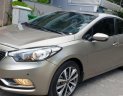 Kia K3 1.6 AT  2013 - Bán Kia K3 1.6 AT số tự động model 2014, Sx 2013, màu vàng 1 đời chủ mới 90%