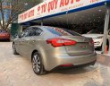 Kia K3   2015 - Cần bán xe Kia K3 1.6AT đời 2015, màu vàng cát, giá tốt