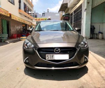 Mazda 2 AT 2016 - Bán Mazda 2 AT sản xuất năm 2016, màu nâu xe gia đình