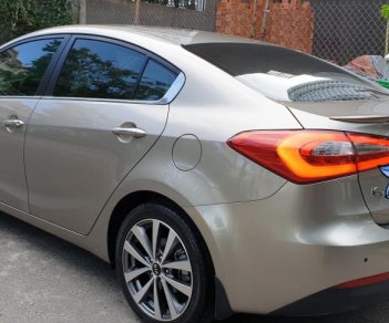 Kia K3 1.6 AT  2013 - Bán Kia K3 1.6 AT số tự động model 2014, Sx 2013, màu vàng 1 đời chủ mới 90%