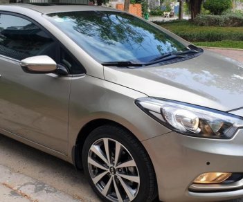 Kia K3 1.6 AT  2013 - Bán Kia K3 1.6 AT số tự động model 2014, Sx 2013, màu vàng 1 đời chủ mới 90%