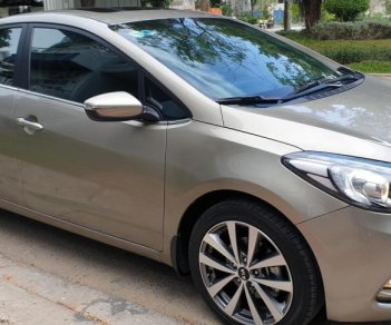 Kia K3 1.6 AT  2013 - Bán Kia K3 1.6 AT số tự động model 2014, Sx 2013, màu vàng 1 đời chủ mới 90%