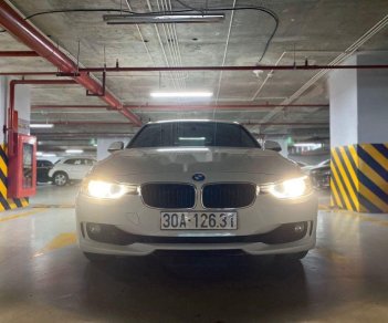 BMW 3 Series   2014 - Cần bán lại xe BMW 320i sản xuất 2014, màu trắng, xe nhập, giá 750tr